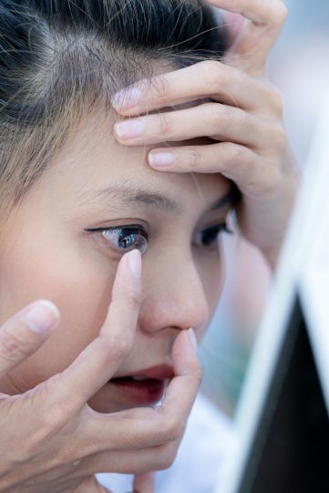 Young woman wearing contact lenses.