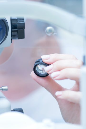 ophthalmologist looks into the viewfinder of a slit lamp for biomicroscopy of the eye