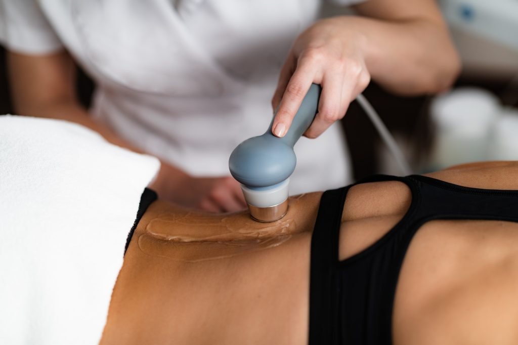 Ultrasound in Physical Therapy. Therapist Using Ultrasound Applicator on a Patient’s Lower Back