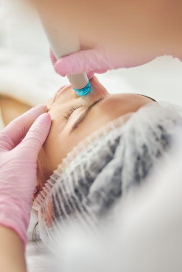 Young Caucasian female undergoing a dermatological procedure