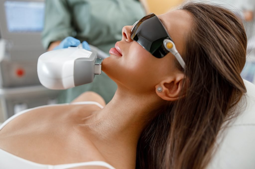 Close up of young woman face getting aesthetic face treatment in beauty salon
