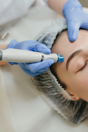 Closeup portrait of beautiful woman during cosmetology therapy in beauty salon. Professional dermato